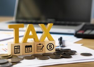 Tax wooden letter and tax icon on wooden block.Pay tax in new year.